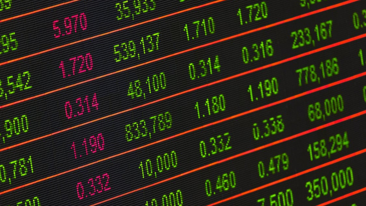 Digital stock market board showing rising indexes and trading data